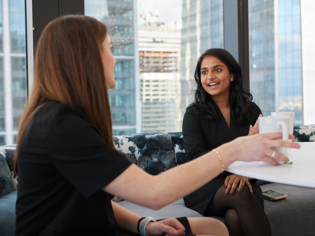 Two colleagues talk to one another